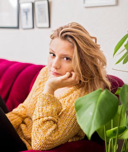 portrait-of-beautiful-woman-sitting-on-sofa-at-home.jpg